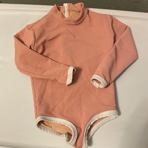 Company -Lain Snow size 12-24 months blush rash guard. Double lined.